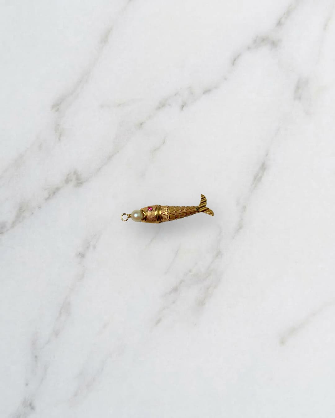 Articulated fish with a pearl